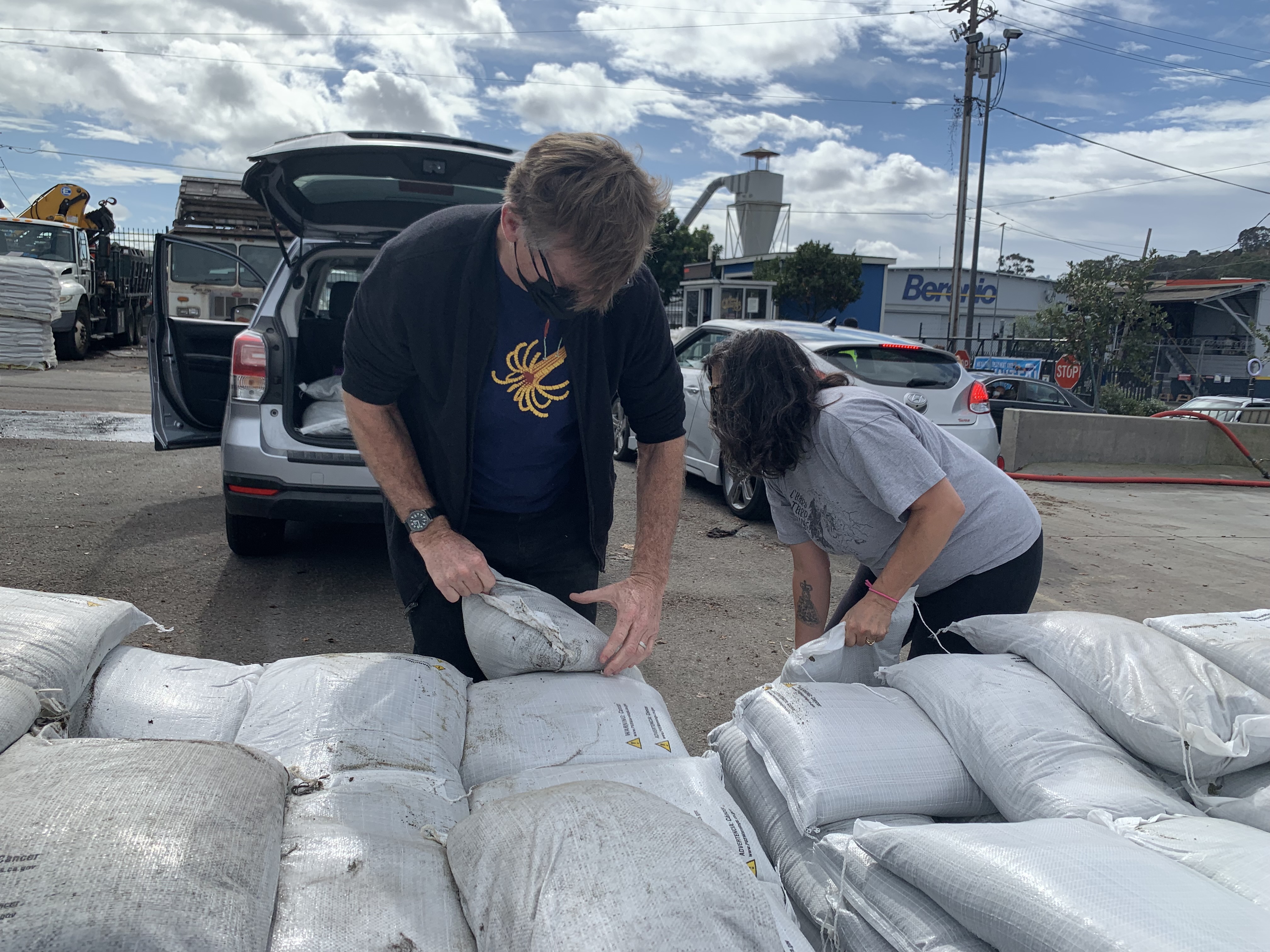 2 people moving sandbags