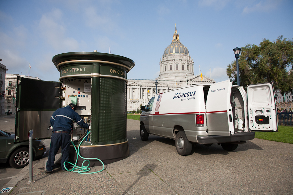 Cleaning crew doing maintenance to a public toilet