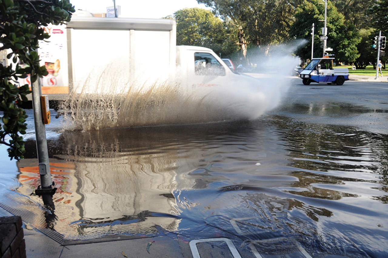 A truck driving through a flooded street