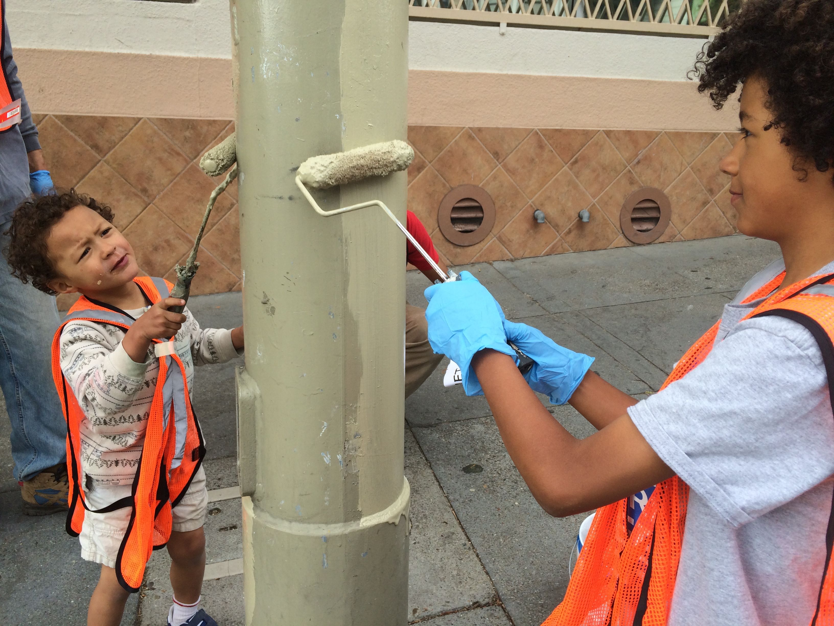 volunteers paint over graffiti