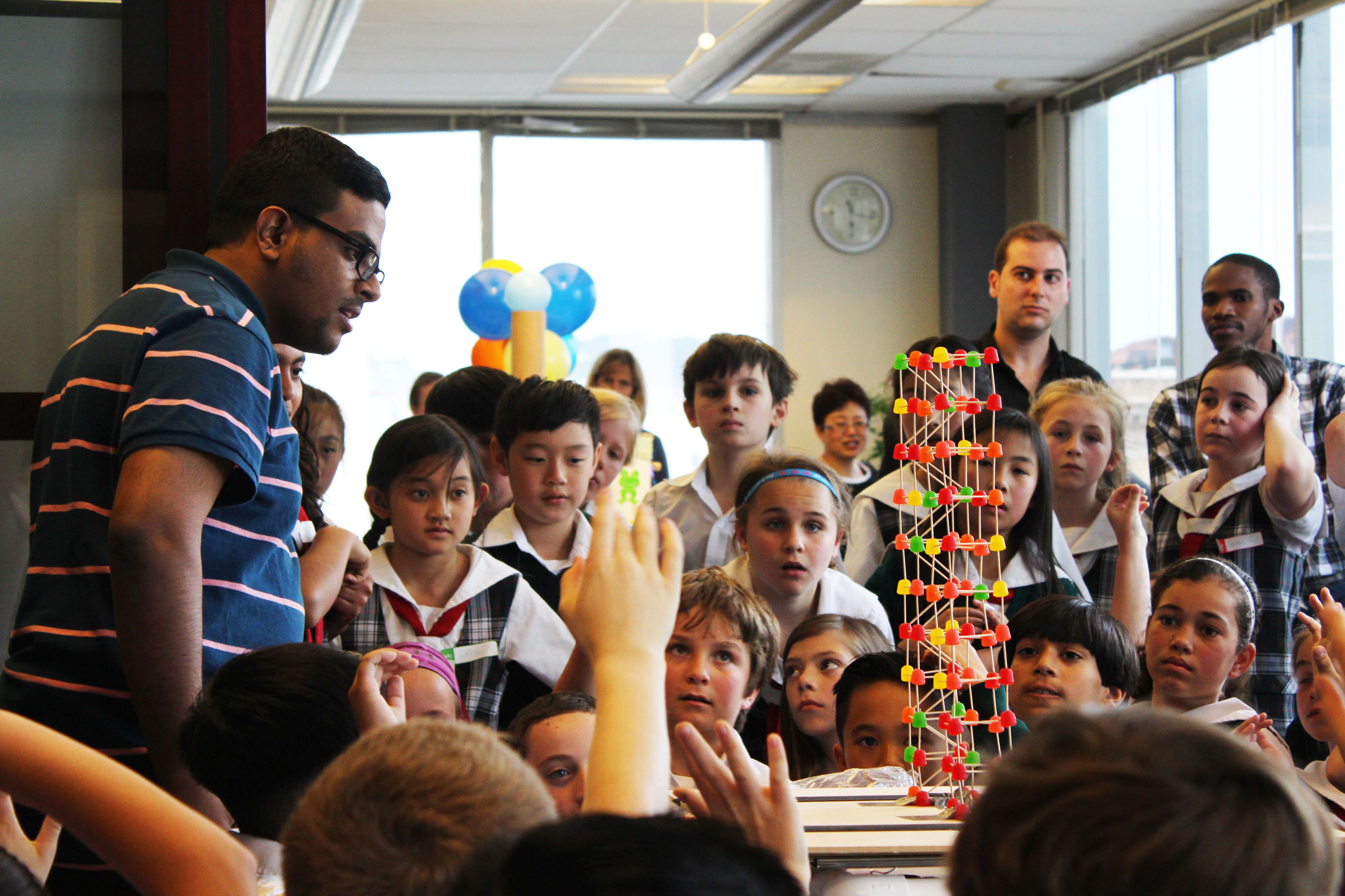 Engineering Open House - Staff test building made out of candy and toothpicks that students created