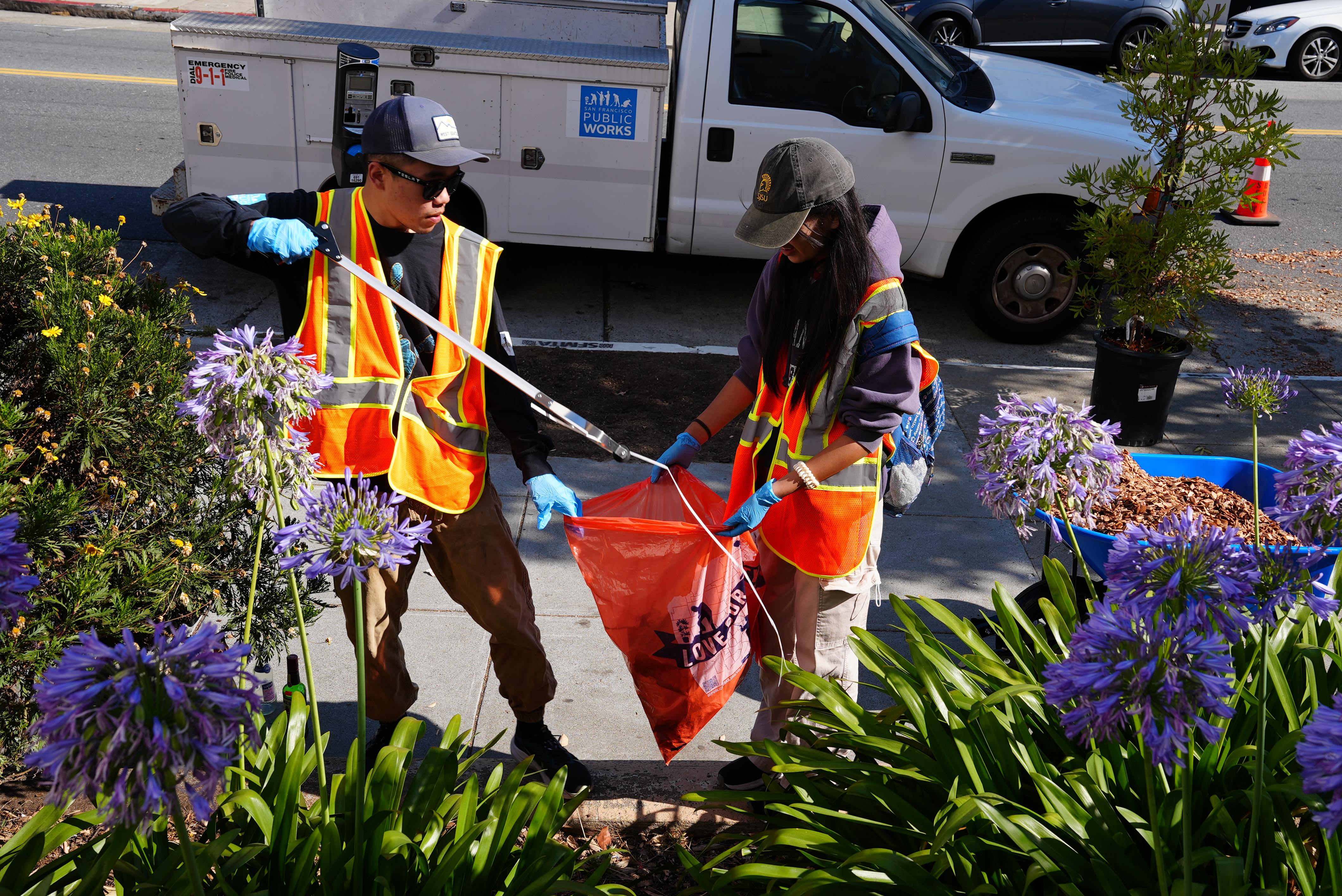 volunteers picking up garbage using a picker