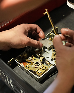 a locksmith cleaning a mortise lock's parts