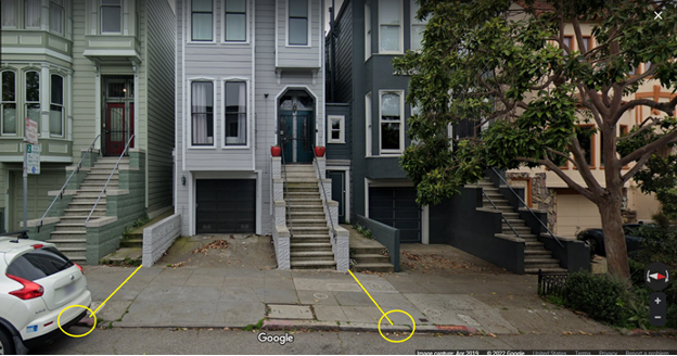 survey monuments indicated by yellow circles on a sidewalk