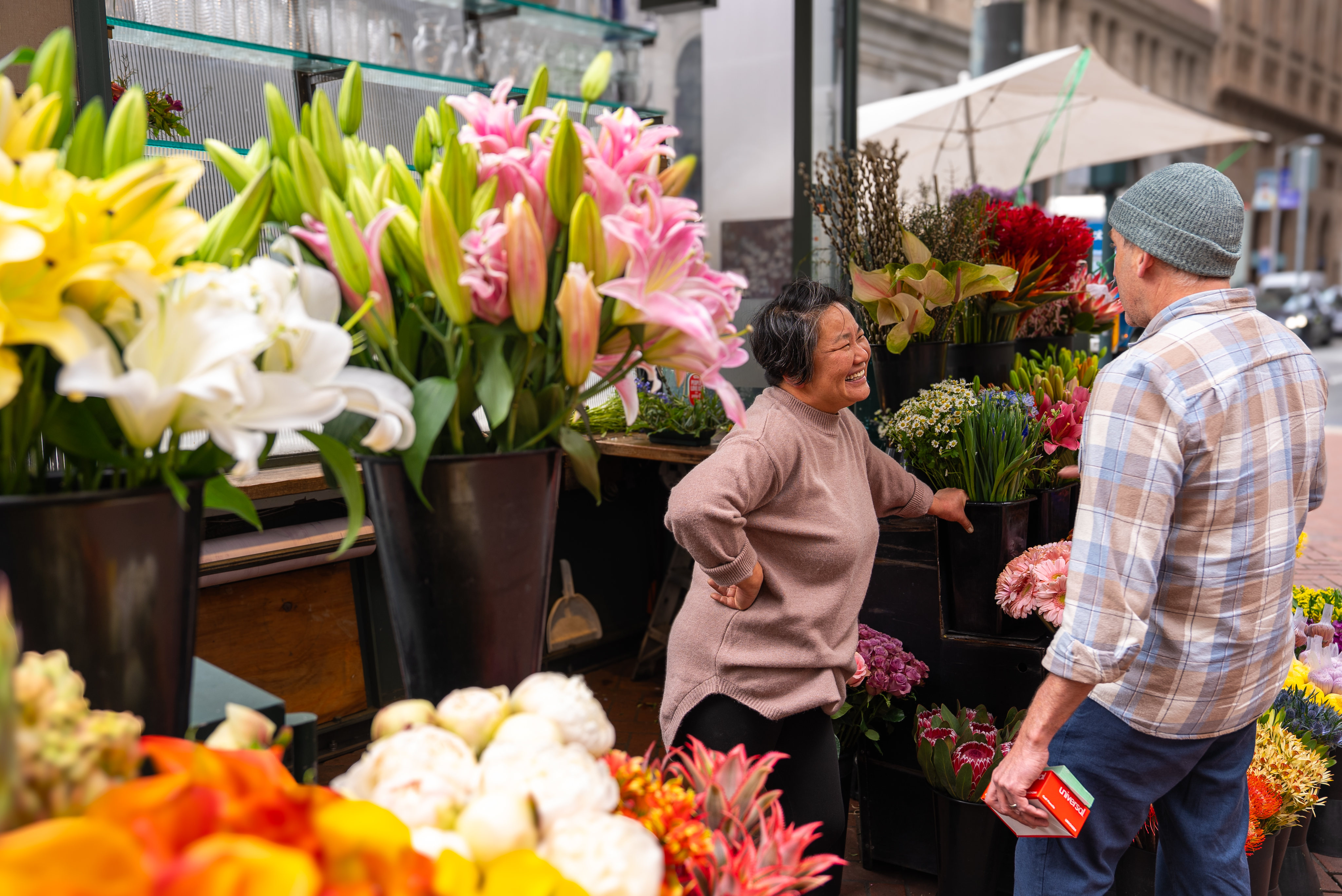 Photo of florist Valerie Chieng talking to a customer. Selling flowers isn’t only about earning a living, it’s also about people-to-people connections.