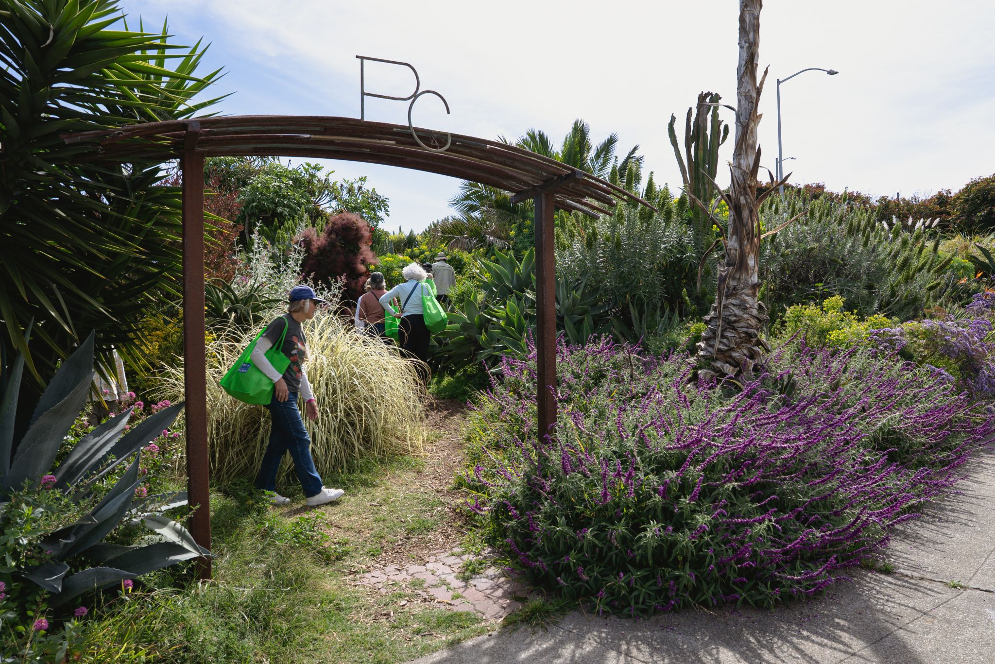 people walking through a street park called Pennsylvania Garden.
