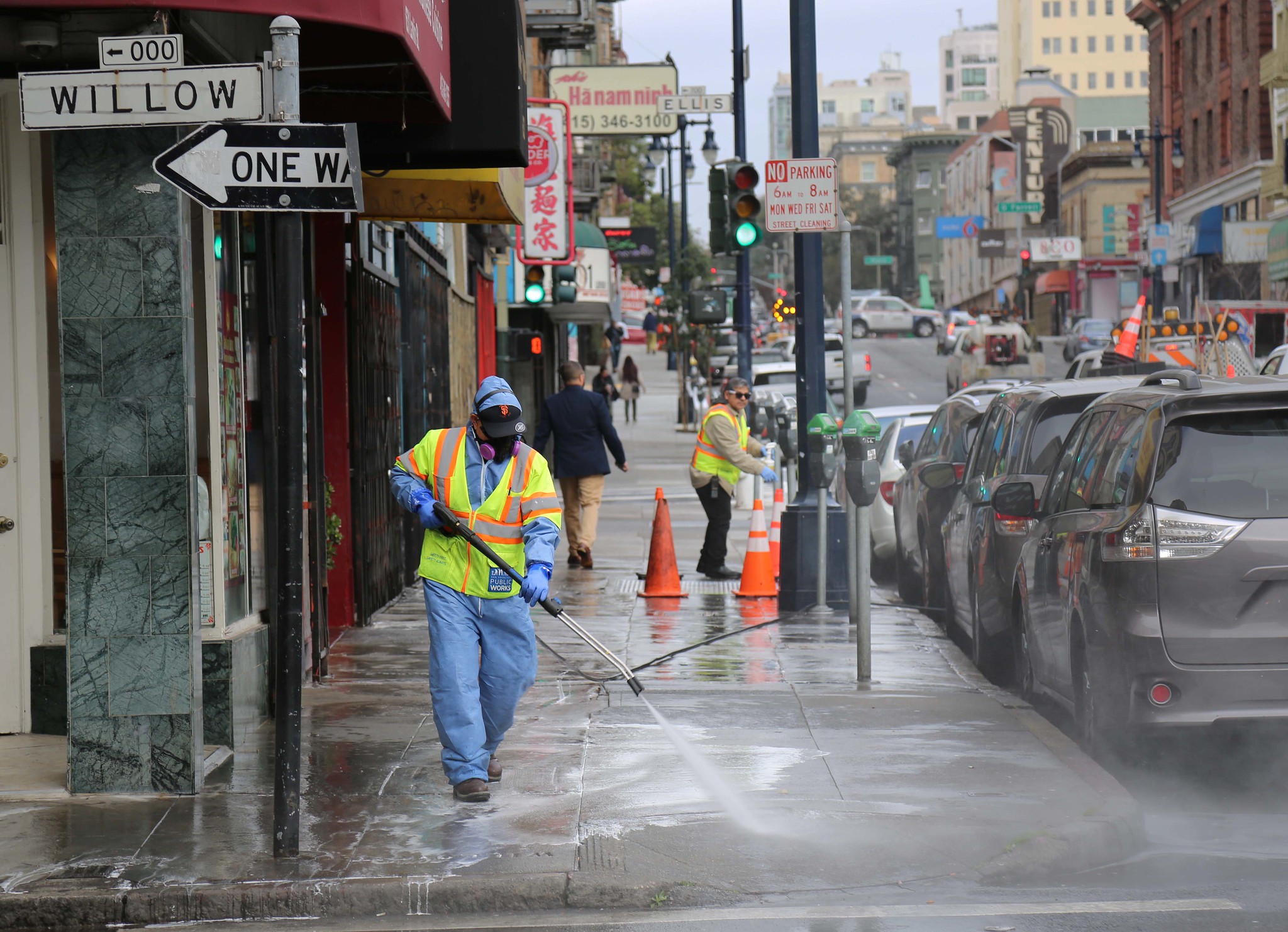 One of our crew members sprays a dirty street in the Little Saigon neighborhood