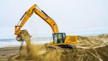 an excavator moving sand at the great highway
