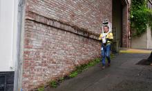 Public Works Architectural Assistant KC Lin walks along the cable car barn in Nob Hill to map the site using a new scanning and surveying tool.