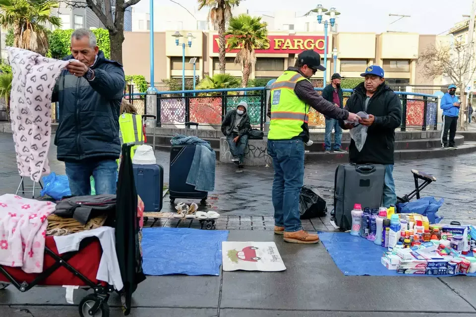 Alejandro Del Calvo speaks with a vendor