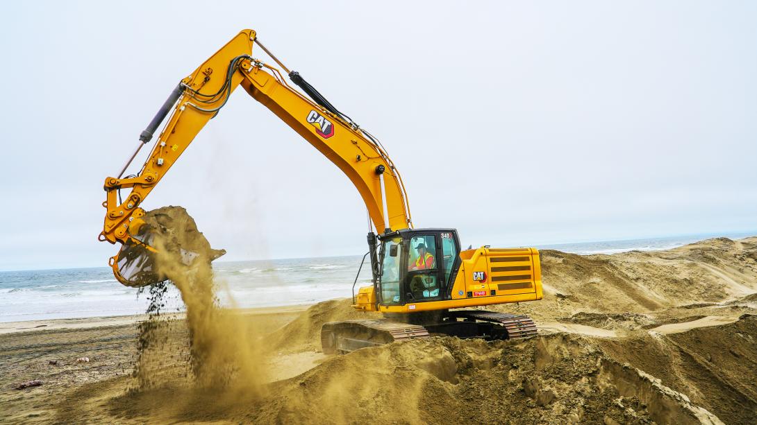 an excavator moving sand at the great highway