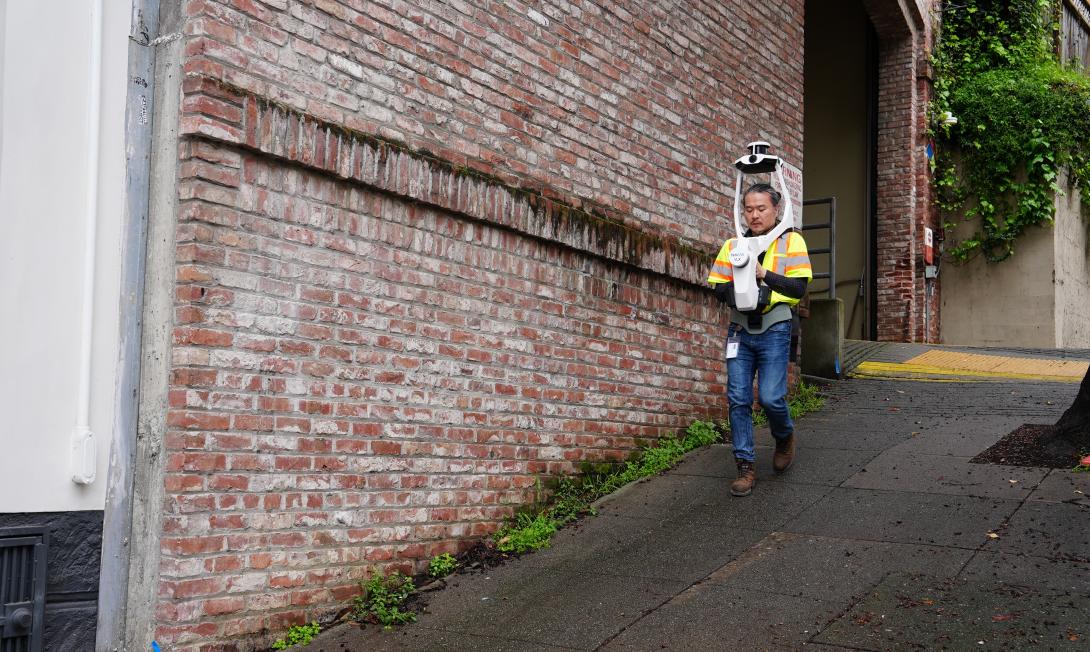 Public Works Architectural Assistant KC Lin walks along the cable car barn in Nob Hill to map the site using a new scanning and surveying tool.